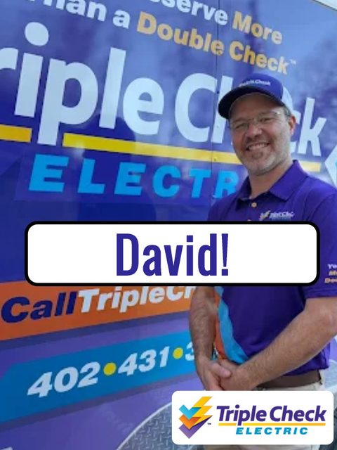 Owner of Triple Check Electric in front of his branded truck